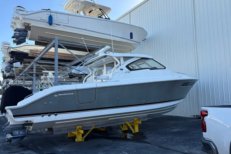 Slide: The Image of 2020 Pursuit DC 365 Dual Console boat in storage, side view. - 19
