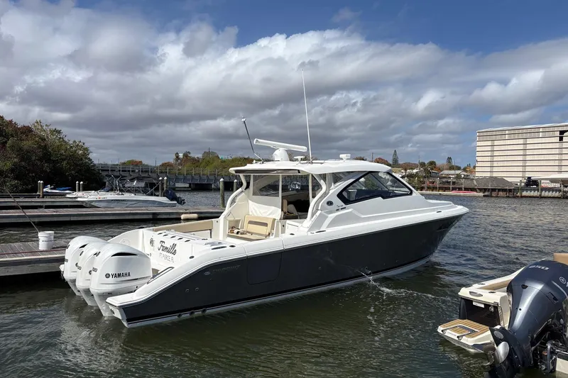 Slide: The Image of 2020 Pursuit DC 365 Dual Console boat docked, featuring Yamaha engines, under a cloudy sky. - 23