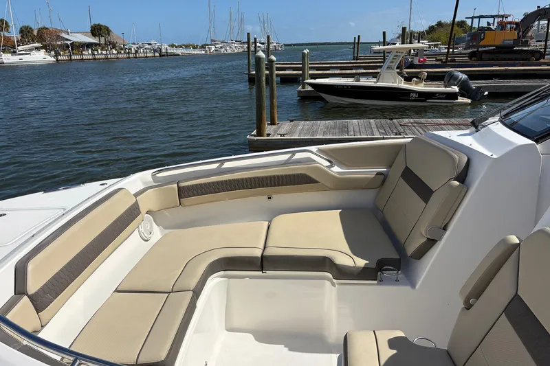 Slide: The Image of 2020 Pursuit DC 365 Dual Console boat with spacious seating at a marina. - 5