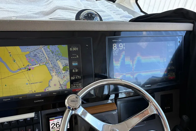 Slide: The Image of 2020 Pursuit DC 365 Dual Console dashboard with Garmin navigation displays and steering wheel. - 7