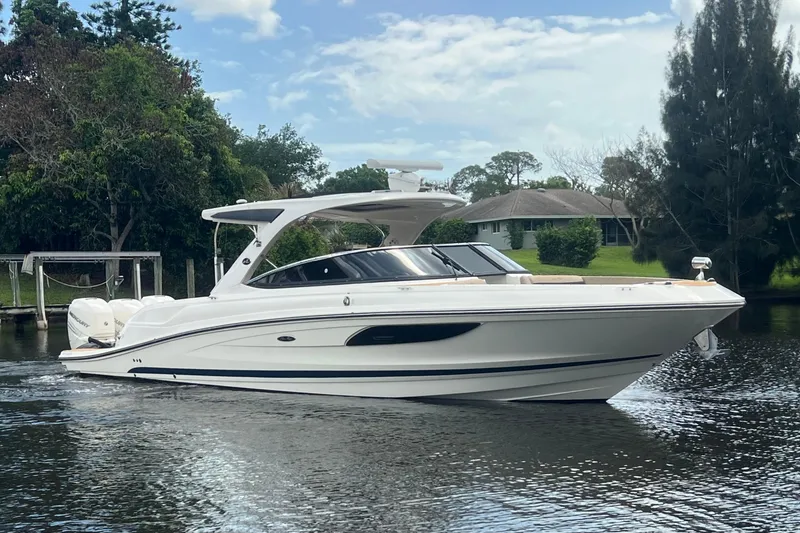 The Image of 2017 Sea Ray SLX 350 Outboard boat cruising on a calm river. - 0