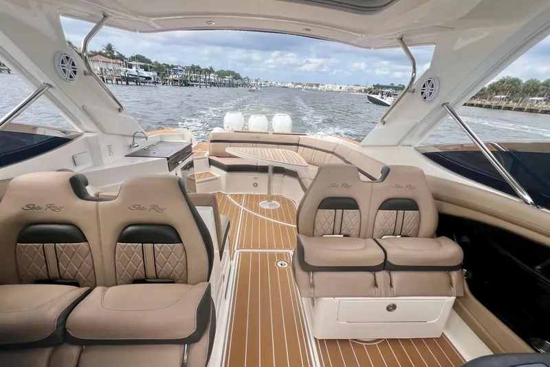 Slide: The Image of Luxurious 2017 Sea Ray SLX 350 Outboard boat interior with elegant seating and scenic water view. - 10
