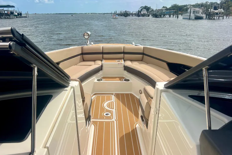 Slide: The Image of 2017 Sea Ray SLX 350 Outboard boat interior with luxurious seating and scenic water view. - 11
