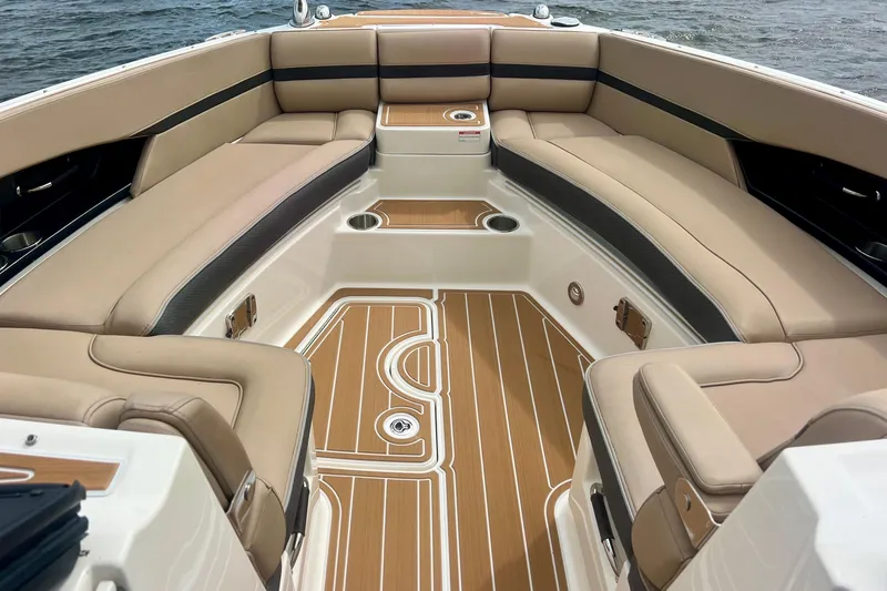 Slide: The Image of Luxurious interior of 2017 Sea Ray SLX 350 Outboard boat with tan seating and wood flooring. - 12