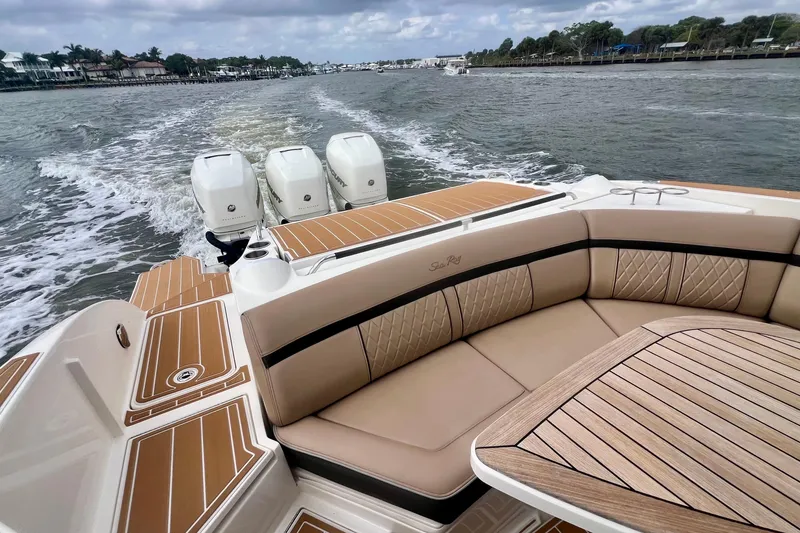 Slide: The Image of 2017 Sea Ray SLX 350 Outboard cruising on a scenic waterway with luxurious seating. - 15