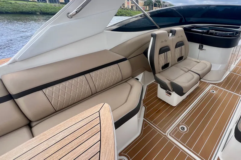 Slide: The Image of Luxurious interior of 2017 Sea Ray SLX 350 Outboard with elegant seating and wood accents. - 17