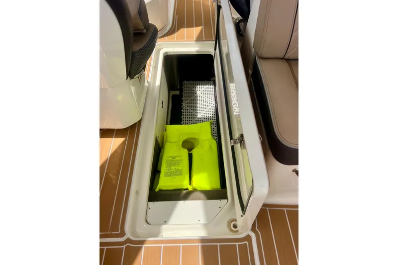 Slide: The Image of Storage compartment on 2017 Sea Ray SLX 350 Outboard with life jacket inside. - 19