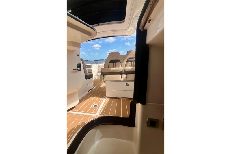 Slide: The Image of Interior view of 2017 Sea Ray SLX 350 Outboard, featuring luxurious seating and teak flooring. - 22