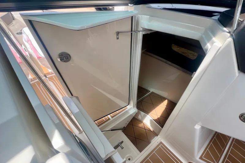 Slide: The Image of 2017 Sea Ray SLX 350 Outboard cabin entrance with open door and teak flooring. - 23