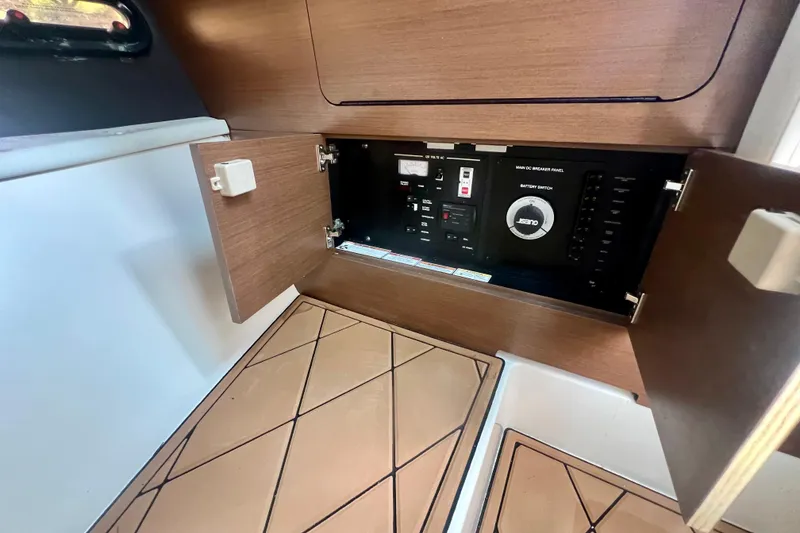 Slide: The Image of 2017 Sea Ray SLX 350 Outboard electrical panel inside wooden cabinet. - 24