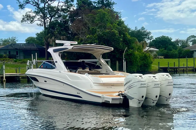 Slide: The Image of 2017 Sea Ray SLX 350 Outboard boat with triple Mercury engines on a calm waterway. - 7