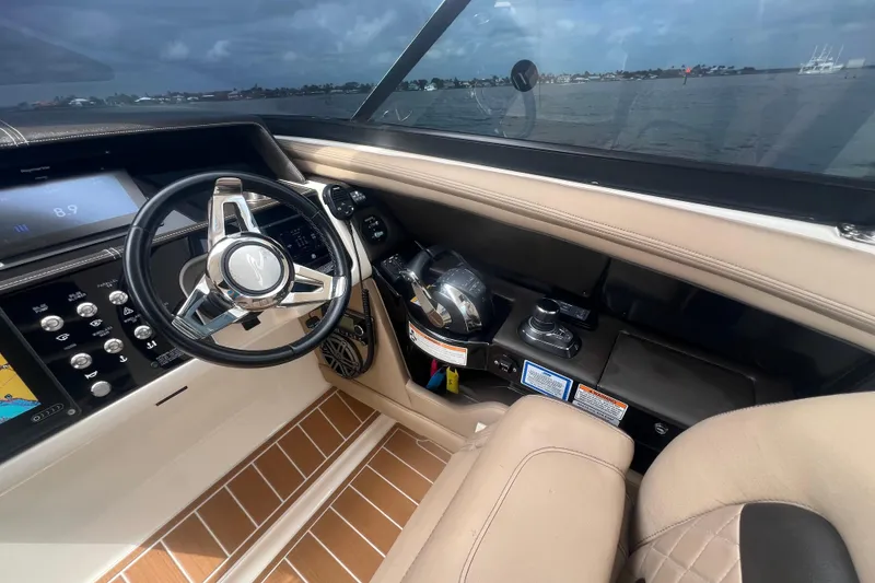 Slide: The Image of 2017 Sea Ray SLX 350 Outboard helm with modern controls and navigation display. - 9