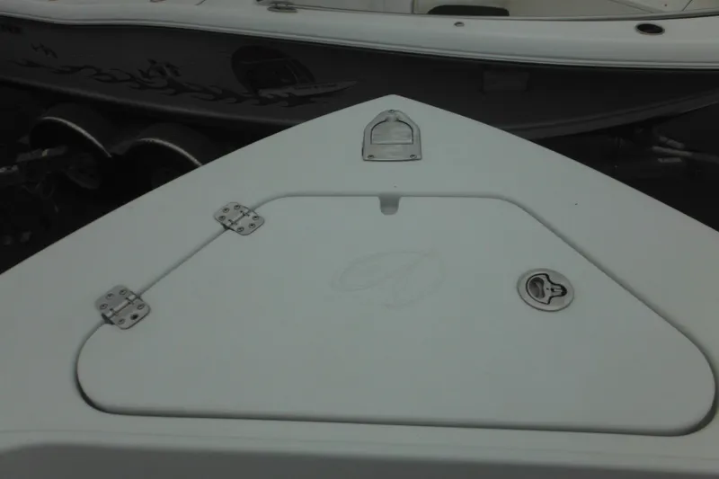 Slide: The Image of Bow of a 2005 Sailfish 218 CC boat with storage compartment and latches. - 11