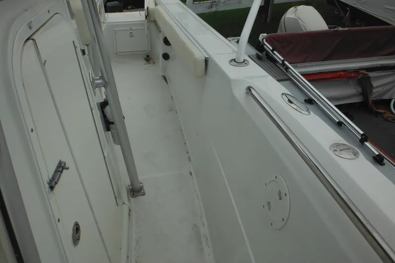 Slide: The Image of 2005 Sailfish 218 CC boat deck with storage compartments and railing. - 16