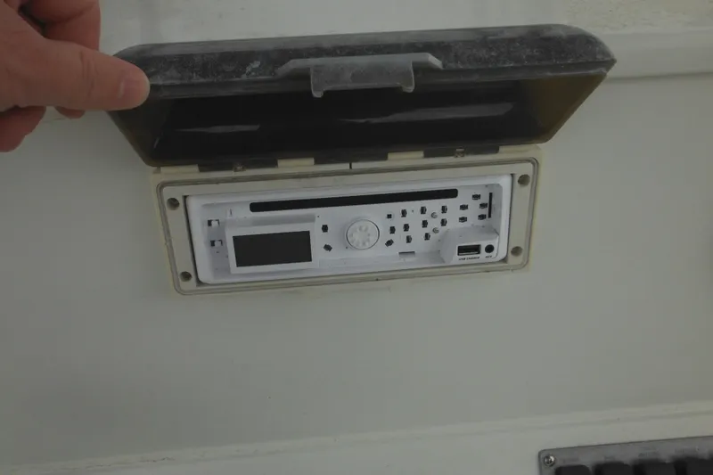 Slide: The Image of 2005 Sailfish 218 CC boat stereo system with protective cover open. - 25