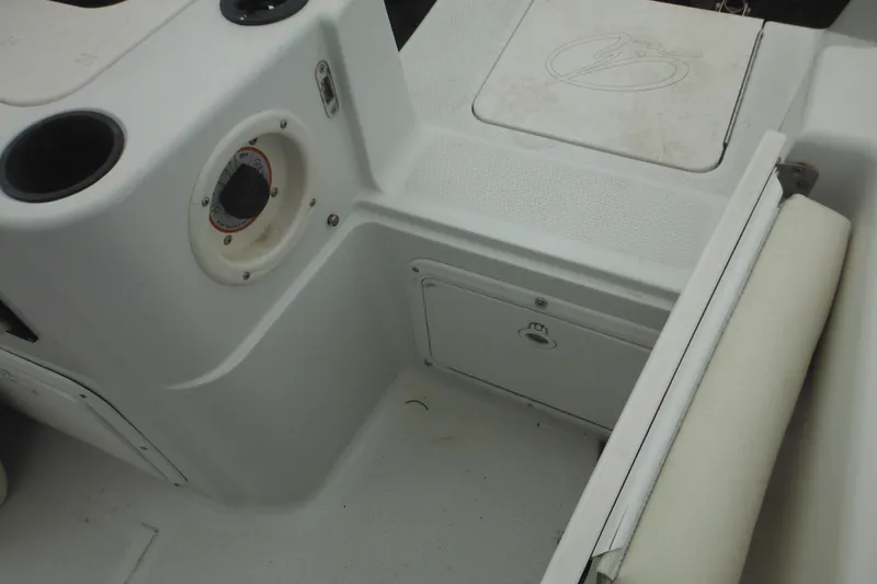 Slide: The Image of Interior view of a 2005 Sailfish 218 CC boat, featuring storage compartments and seating. - 28