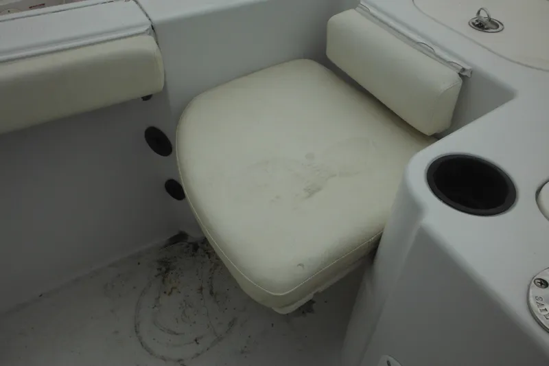Slide: The Image of White seat on 2005 Sailfish 218 CC boat, featuring cup holder and storage compartment. - 29