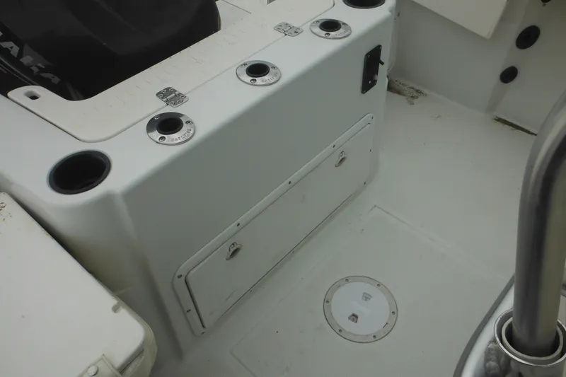 Slide: The Image of 2005 Sailfish 218 CC boat interior with rod holders and storage compartments. - 30