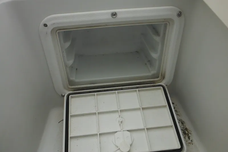 Slide: The Image of Open storage compartment on a 2005 Sailfish 218 CC boat. - 32