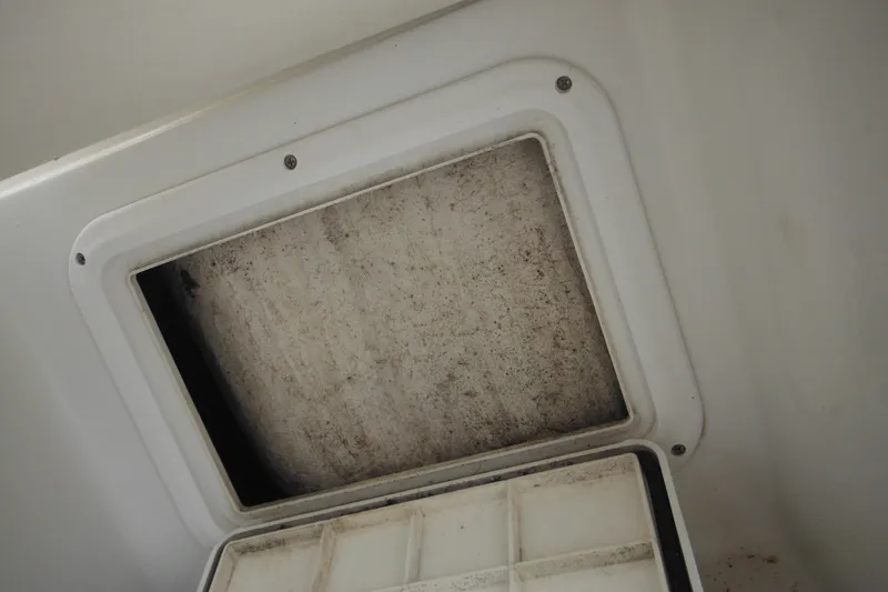 Slide: The Image of Inspection hatch of a 2005 Sailfish 218 CC boat, showing interior details. - 35