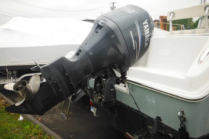 Slide: The Image of 2005 Sailfish 218 CC boat with Yamaha outboard motor, parked on a trailer. - 6