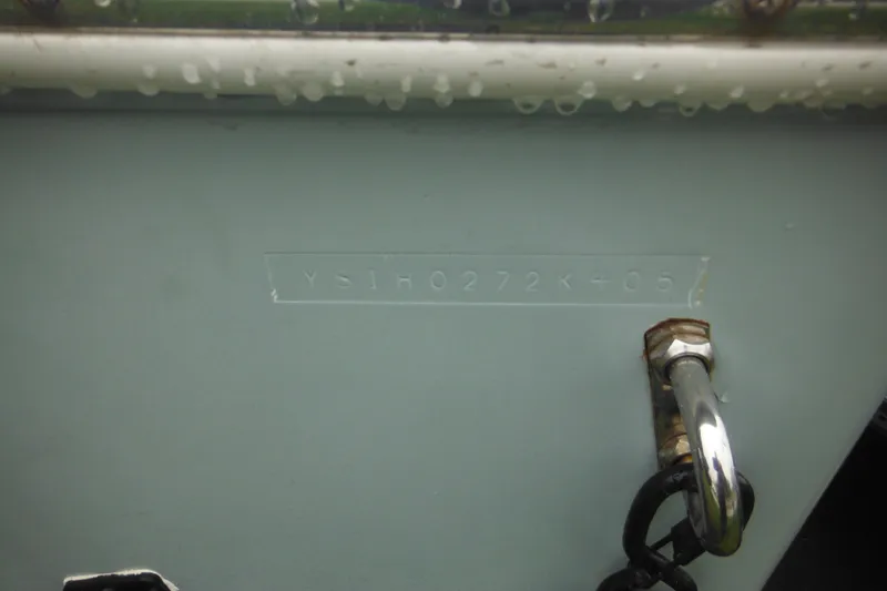Slide: The Image of Hull identification number on 2005 Sailfish 218 CC boat with metal chain attachment. - 7