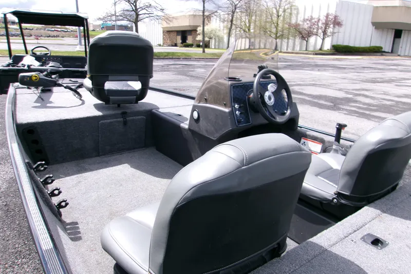 Slide: The Image of 2023 Tracker Bass Tracker Classic XL boat interior with steering wheel and seating. - 3