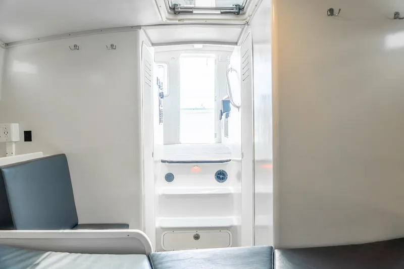 Slide: The Image of Interior of a 2018 Northern Bay 38 boat, featuring seating and a bright cabin entrance. - 41