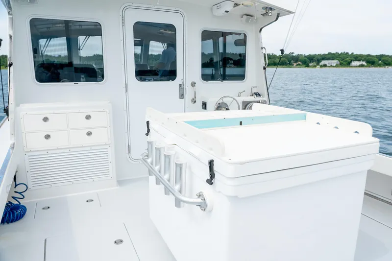 Slide: The Image of Northern Bay 38 boat interior, 2018 model, featuring storage drawers and fishing equipment. - 22