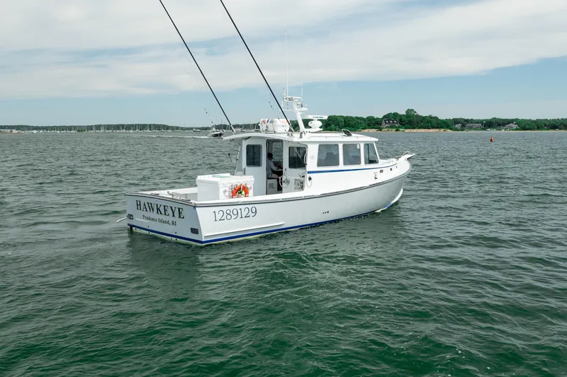 Slide: The Image of 2018 Northern Bay 38 boat named "Hawkeye" on open water near shore. - 9