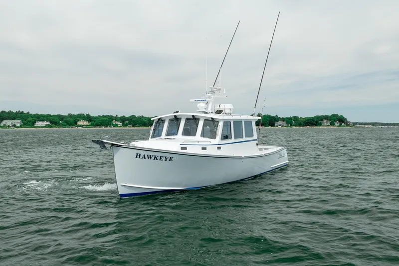Slide: The Image of 2018 Northern Bay 38 boat named "Hawkeye" cruising on a calm sea. - 3