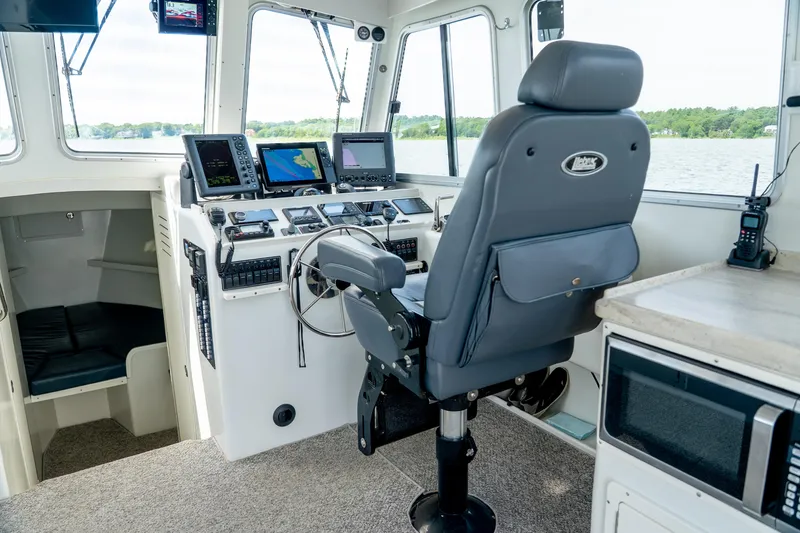 Slide: The Image of Helm of 2018 Northern Bay 38 boat with navigation equipment and captain's chair. - 29