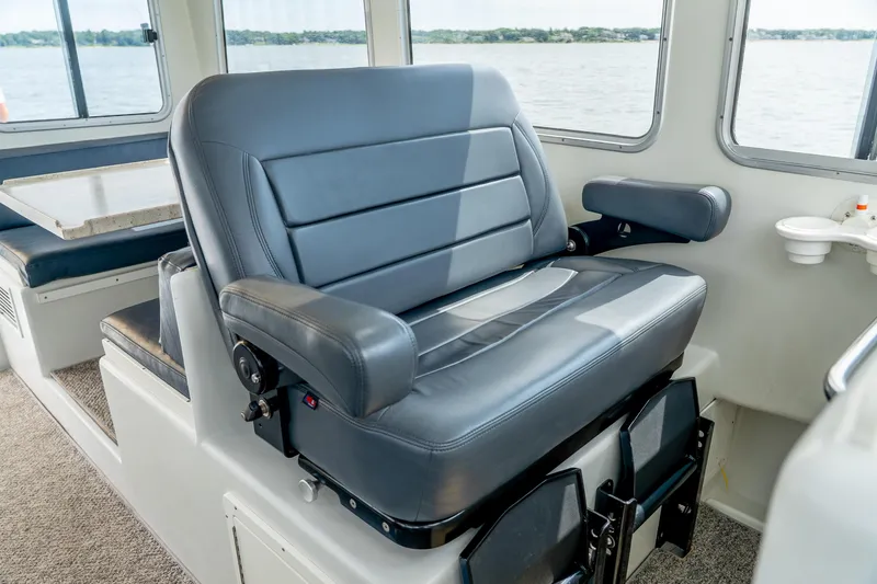 Slide: The Image of Captain's chair in 2018 Northern Bay 38 boat interior, featuring comfortable seating and scenic window views. - 34