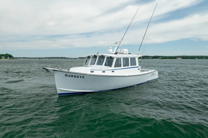 Slide: The Image of 2018 Northern Bay 38 boat named "Hawkeye" on open water under a cloudy sky. - 15
