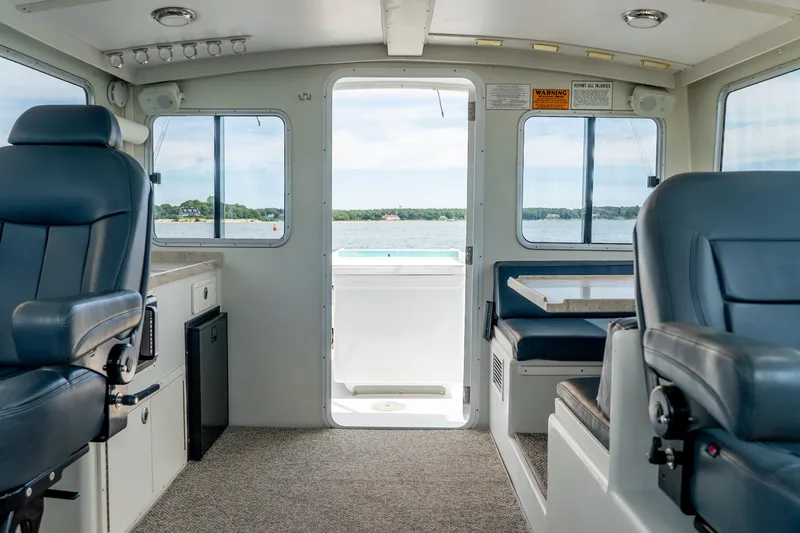 Slide: The Image of Interior of 2018 Northern Bay 38 boat with seating and water view through open door. - 33