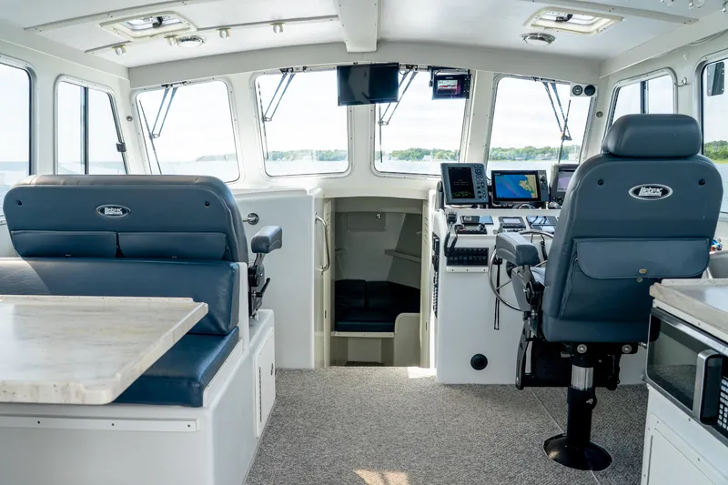 Slide: The Image of Interior of 2018 Northern Bay 38 boat with modern navigation equipment and seating. - 27