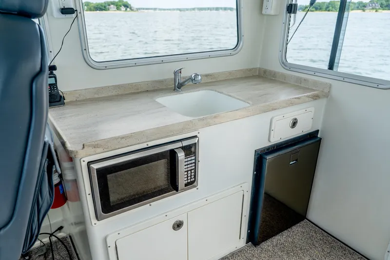 Slide: The Image of Interior of 2018 Northern Bay 38 boat with kitchenette, sink, and microwave. - 36