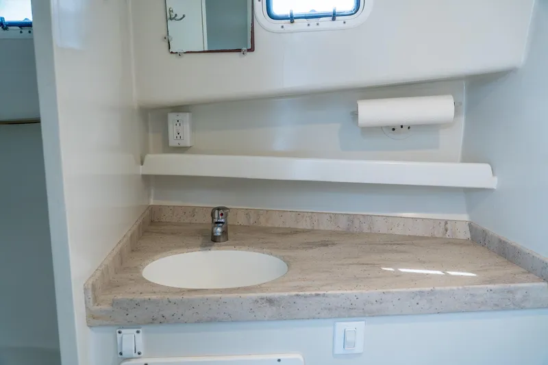 Slide: The Image of Modern bathroom sink area in 2018 Northern Bay 38 boat, featuring a sleek countertop design. - 39