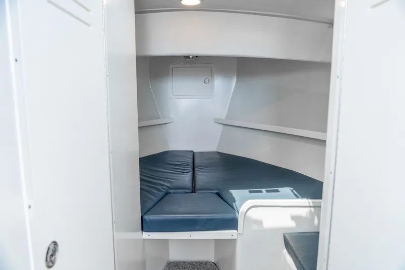 Slide: The Image of Interior cabin of 2018 Northern Bay 38 boat with blue cushions and white walls. - 40