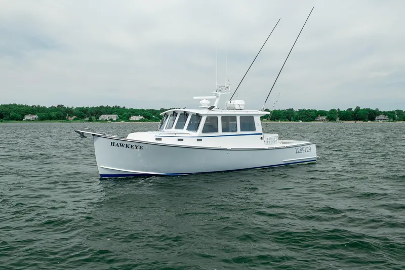 Slide: The Image of 2018 Northern Bay 38 boat named "Hawkeye" on calm waters. - 2