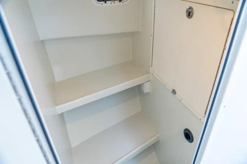 Slide: The Image of Interior storage compartment of 2018 Northern Bay 38 boat, featuring shelves and a secure hatch. - 37