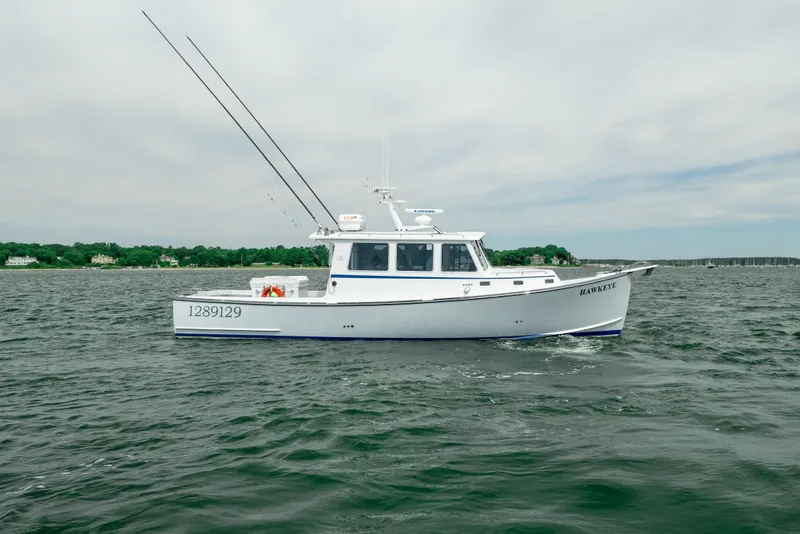 Slide: The Image of 2018 Northern Bay 38 boat cruising on open water under a cloudy sky. - 7