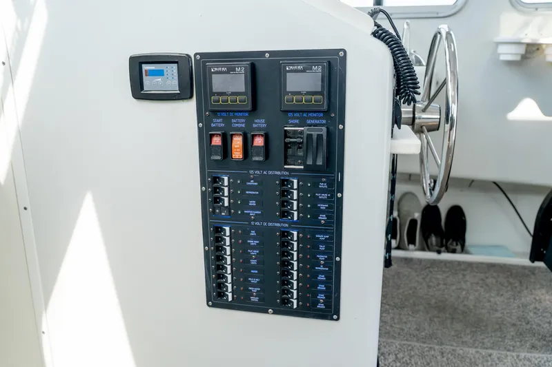 Slide: The Image of Electrical control panel on a 2018 Northern Bay 38 boat, featuring switches and monitors. - 32