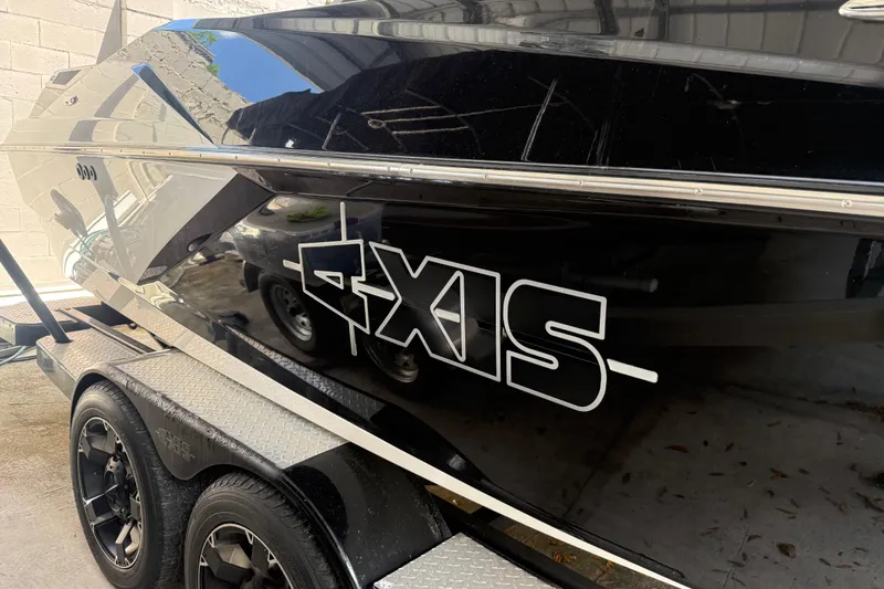 Slide: The Image of 2016 Axis A22 boat on trailer, black exterior with logo. - 5