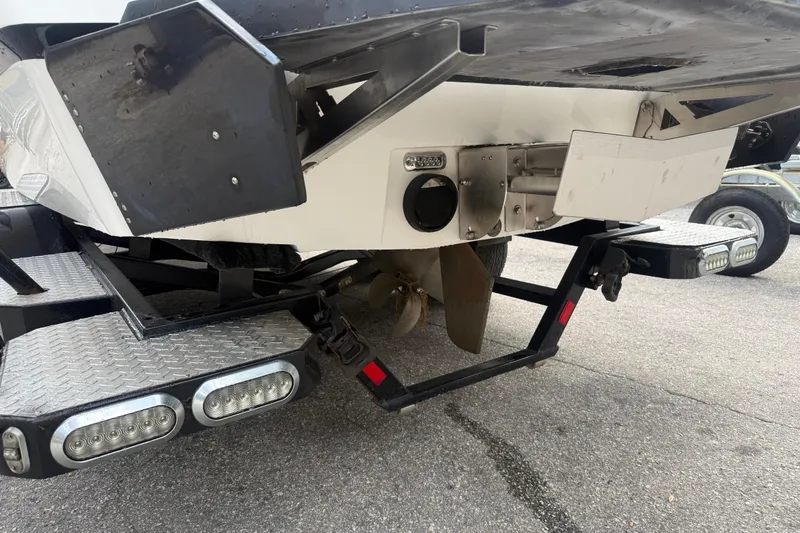 Slide: The Image of 2016 Axis A22 boat stern with propeller and trailer lights visible. - 6