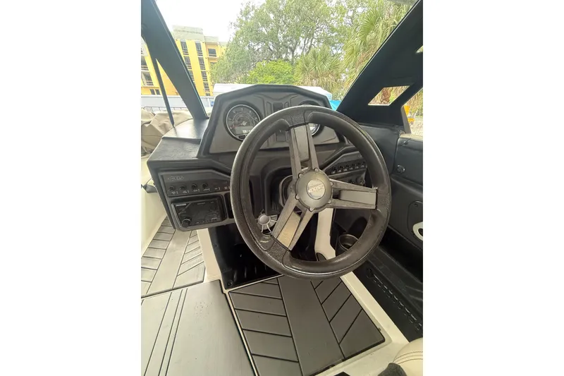 Slide: The Image of 2016 Axis A22 boat dashboard with steering wheel and control panel. - 7