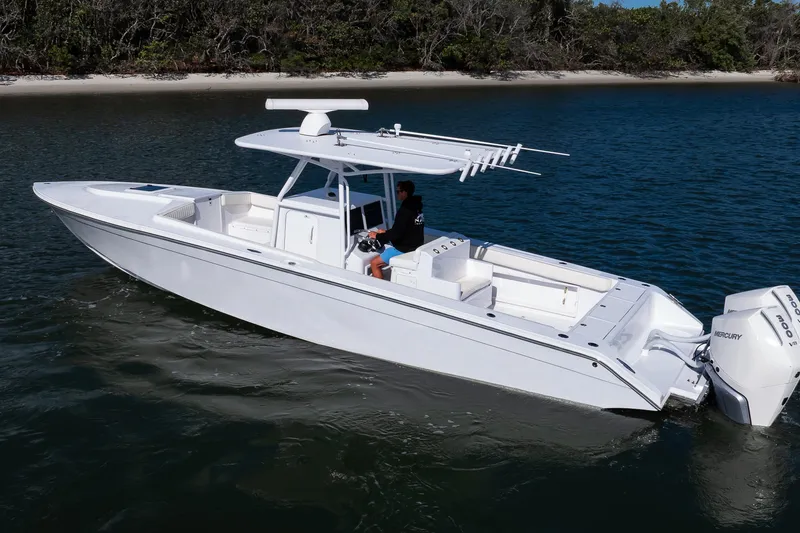 Slide: The Image of 1997 Marlago 35fs boat cruising on a calm waterway near a forested shoreline. - 10