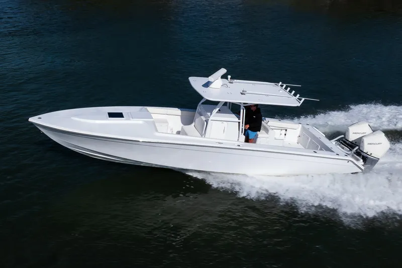 Slide: The Image of 1997 Marlago 35fs boat cruising on water with dual Mercury engines. - 11