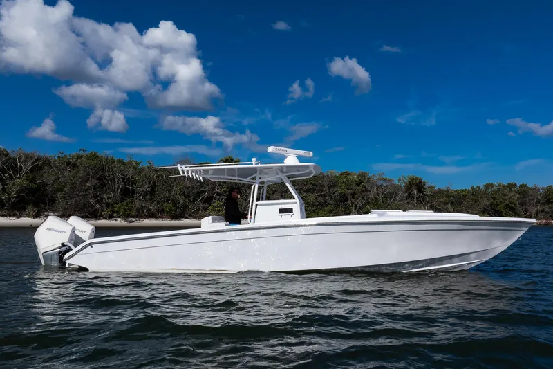 Slide: The Image of 1997 Marlago 35fs boat on water with clear blue sky background. - 12