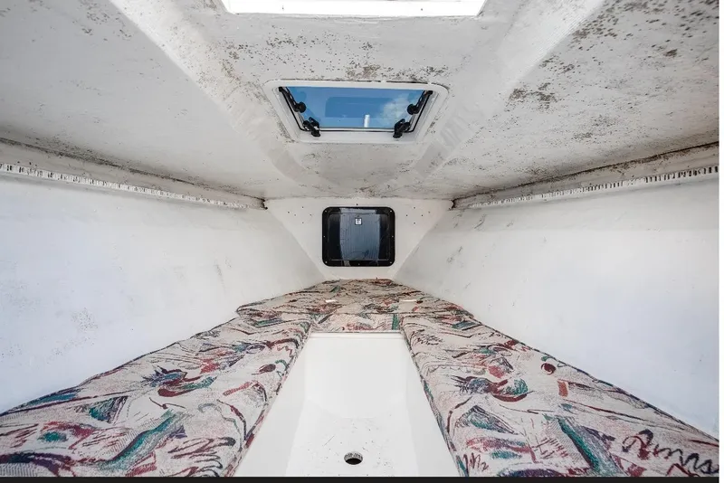 Slide: The Image of Interior cabin of a 1997 Marlago 35fs boat with patterned cushions. - 13